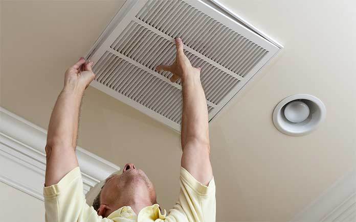 Man changing air conditioner filter